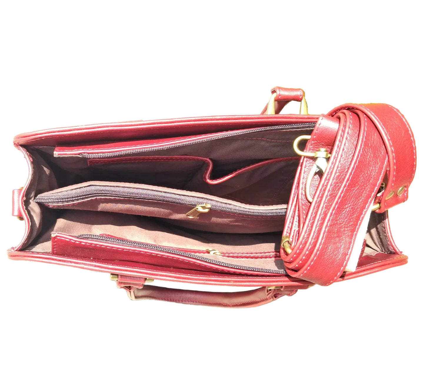A cherry red Cape designer Laptop bag handbaginside with gold accents on a white background