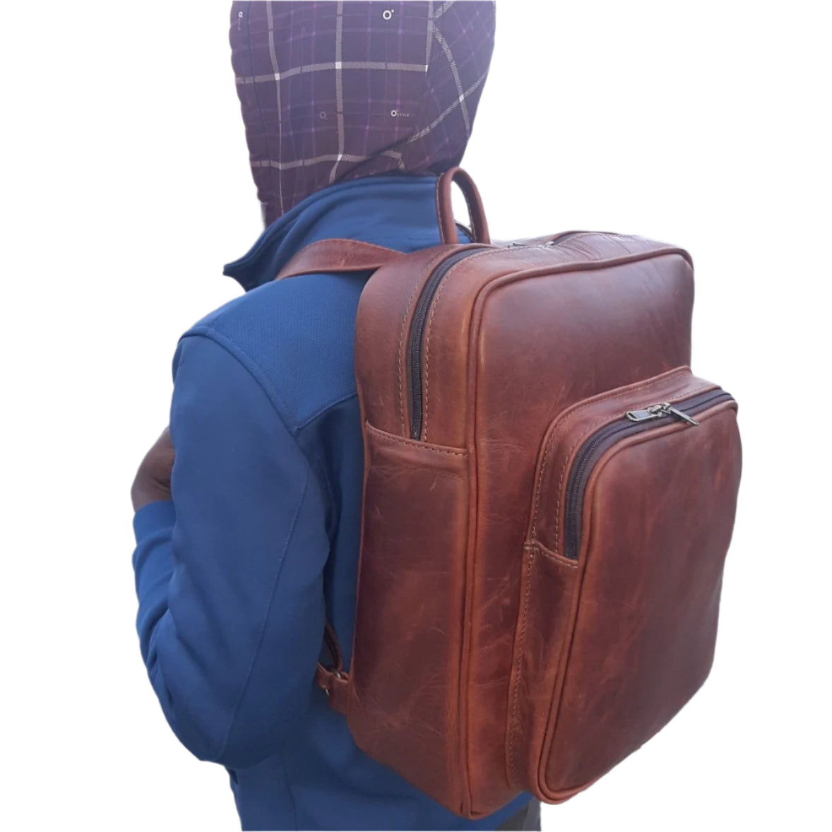 A boy carrying genuine leather Everyday Laptop Backpacks 15" in pitstop cigar colour from Cape Masai Leather