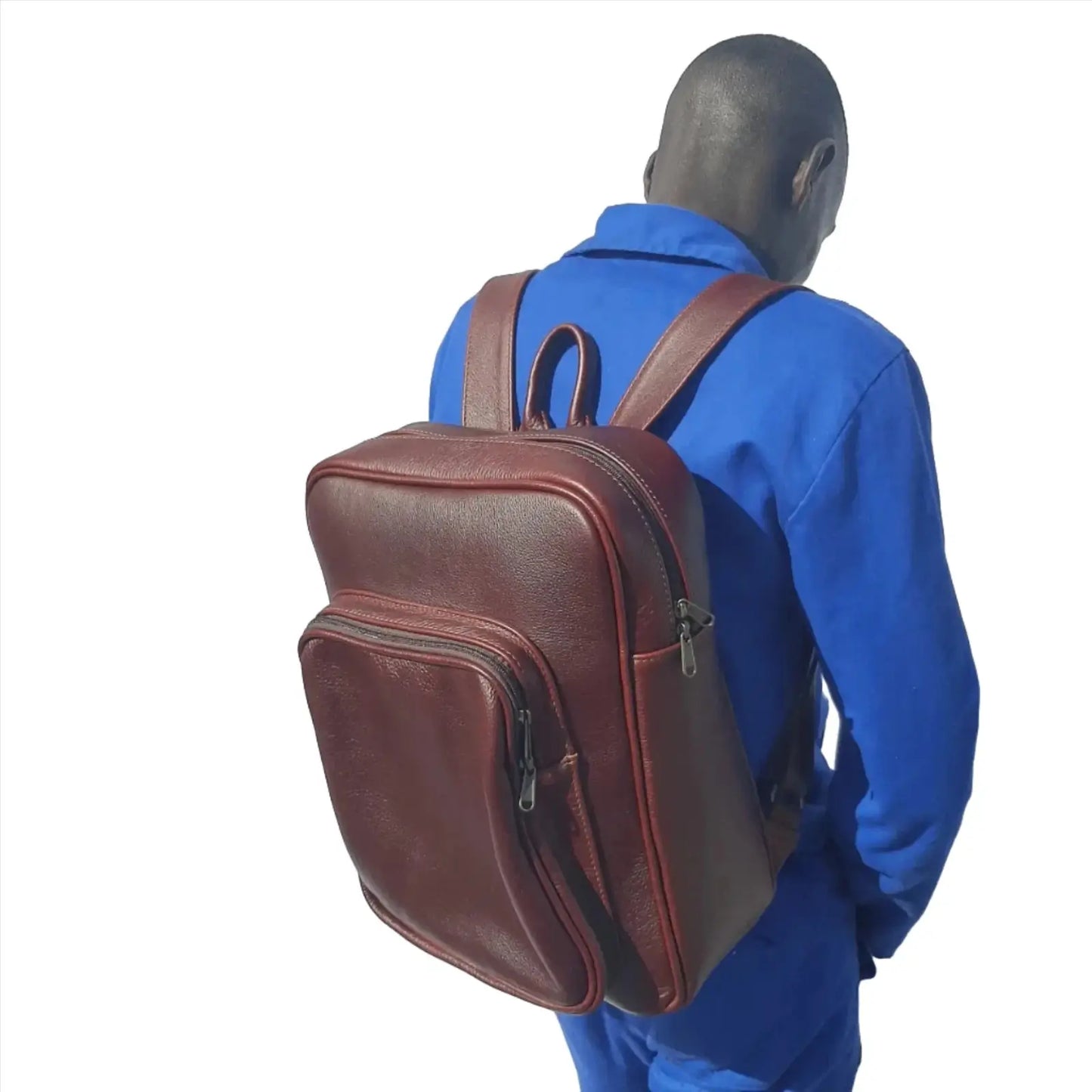 A worker in blue uniform carrying a beautiful Everyday Laptop backpack 15 made by Cape Masai Leather on his back