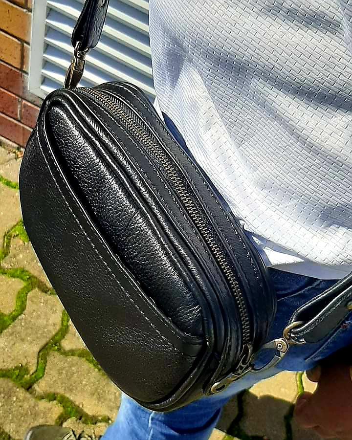 a beautiful lady carrying Lady X Leather Sling in black