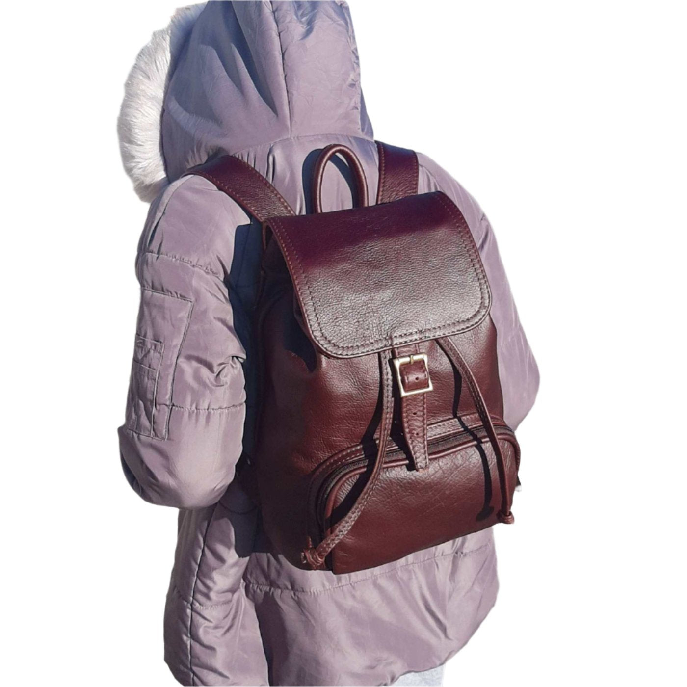 A young lady carrying a beautiful genuine leather backpack with flap in dark tan from Cape Masai Leather