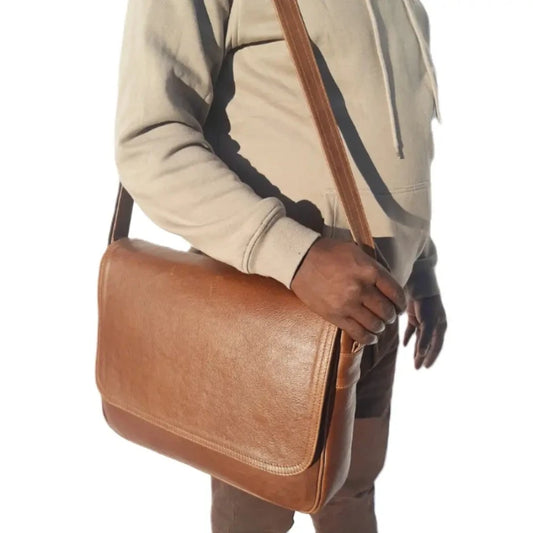 a man carry a Men's laptop bag 15" from Cape Masai leather