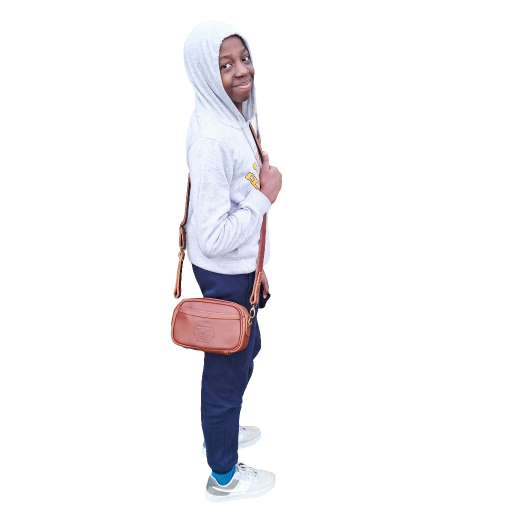 a beautiful younger lady carrying Lady X Leather Sling in cherry red