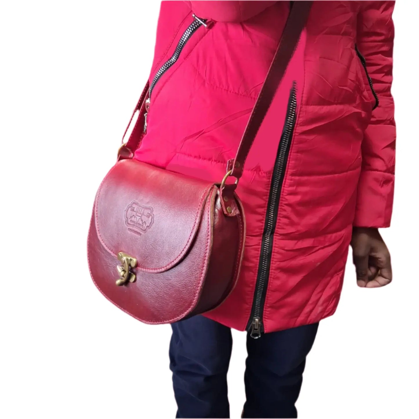Person wearing a red jacket holding a cherry red D Bag big leather bags