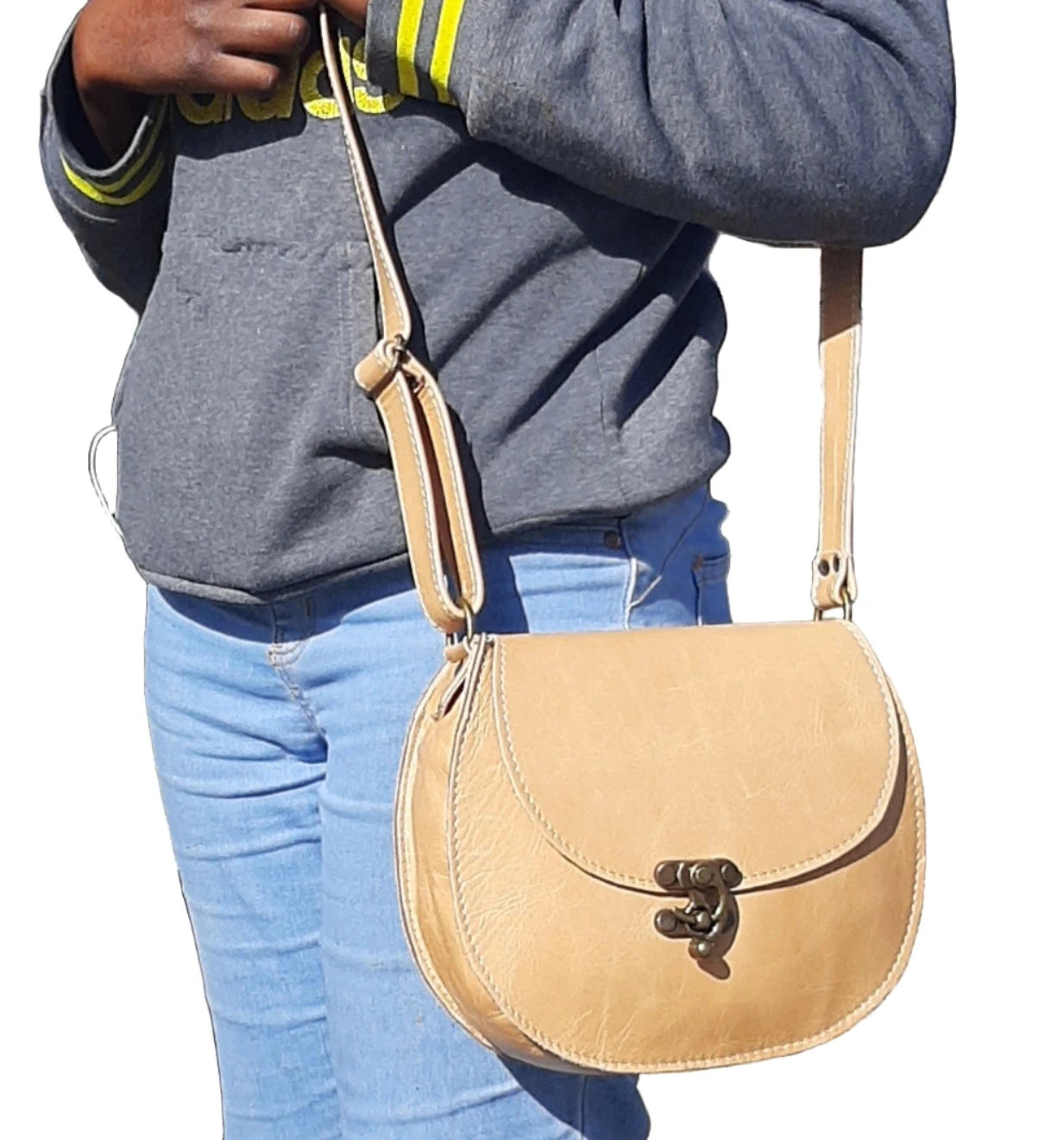 A beatiful  lady carrying a beautiful Crossbody "D Bag big leather bags / Mini Sandle bags" at Cape Masai leather in Cape Town  