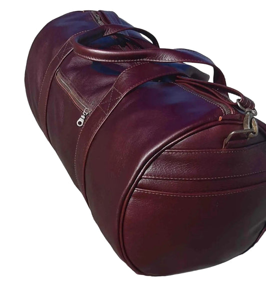 Duffle  travel  bags dark tan from Cape Masai Leather standing on the ground 