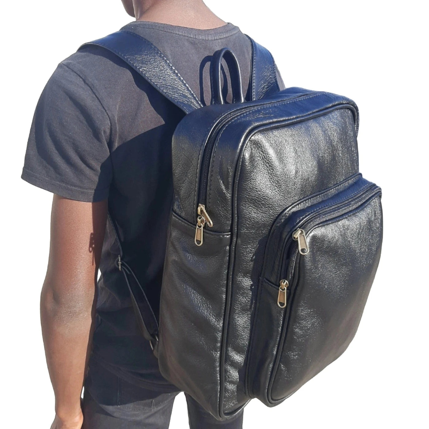 A boy carrying Everyday Leather Backpacks XL in black colour from Cape Masai Leather 