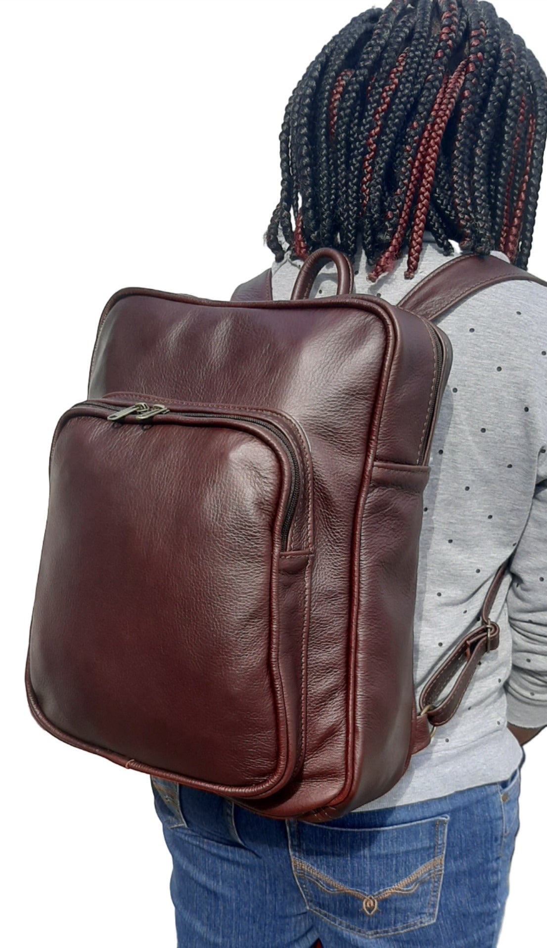 A beautiful African lady carrying a beautiful genuine leather backpack from Cape Masai Leather.