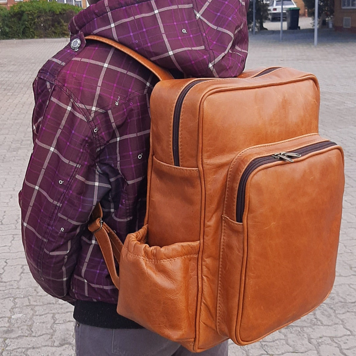 A boy carrying Everyday Leather Backpacks XL in light tan colour from Cape Masai Leather
