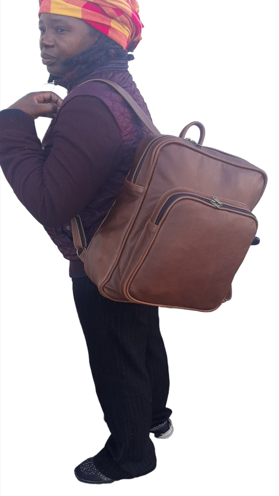 A lady carrying a beautiful genuine leather everyday backpack in pecan tan colour from Cape Masai Leather 