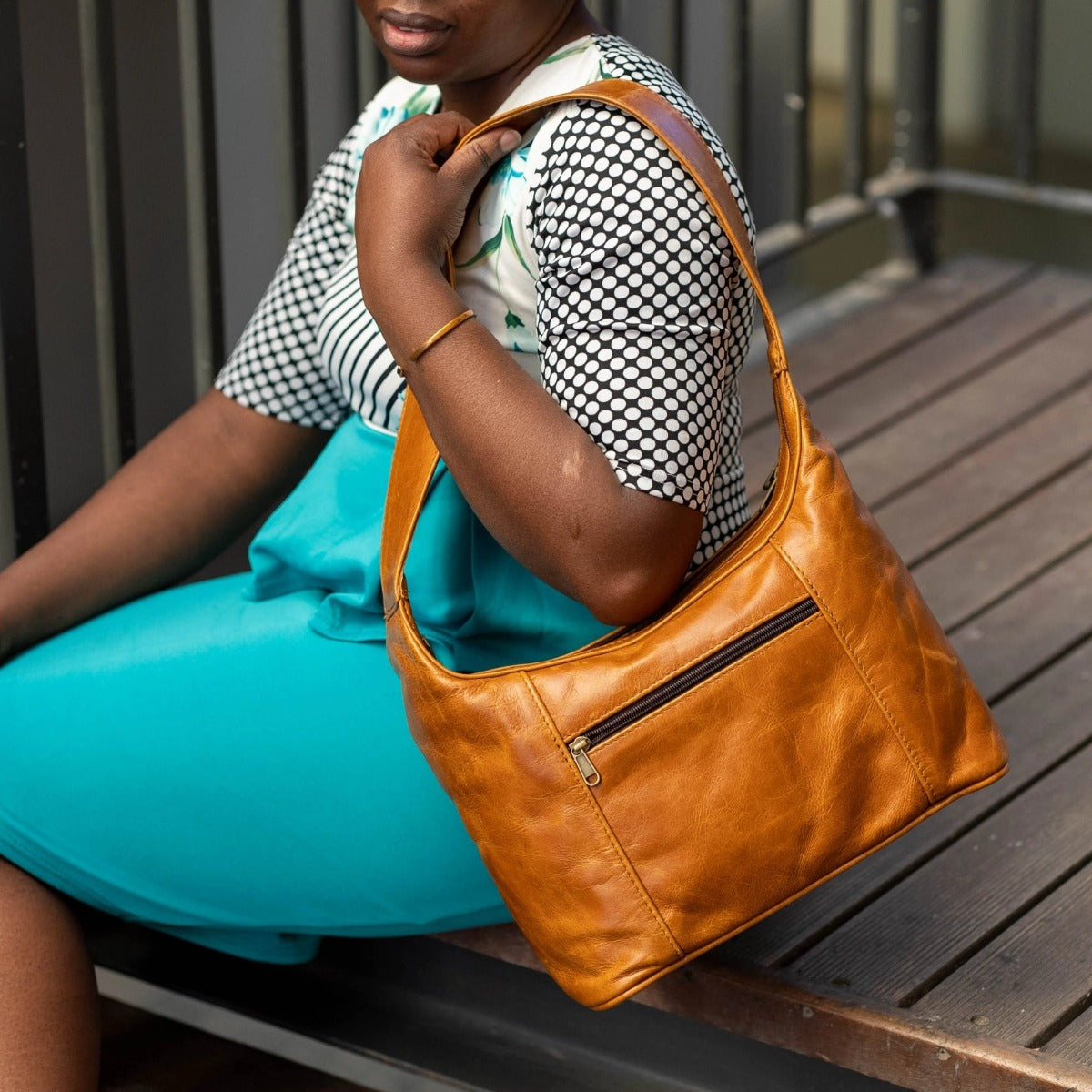 A lady carrying Gb7 leather bags in light tan made by cape Masai Leather