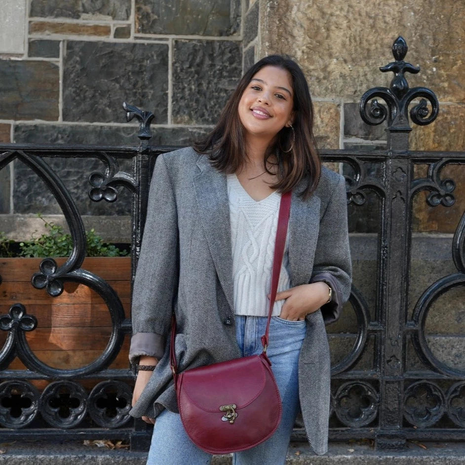 A beatiful lady carrying a beautiful Crossbody "D Bag big leather bags / Mini Sandle bags" from Cape Masai leather at Green market Square in Cape Town