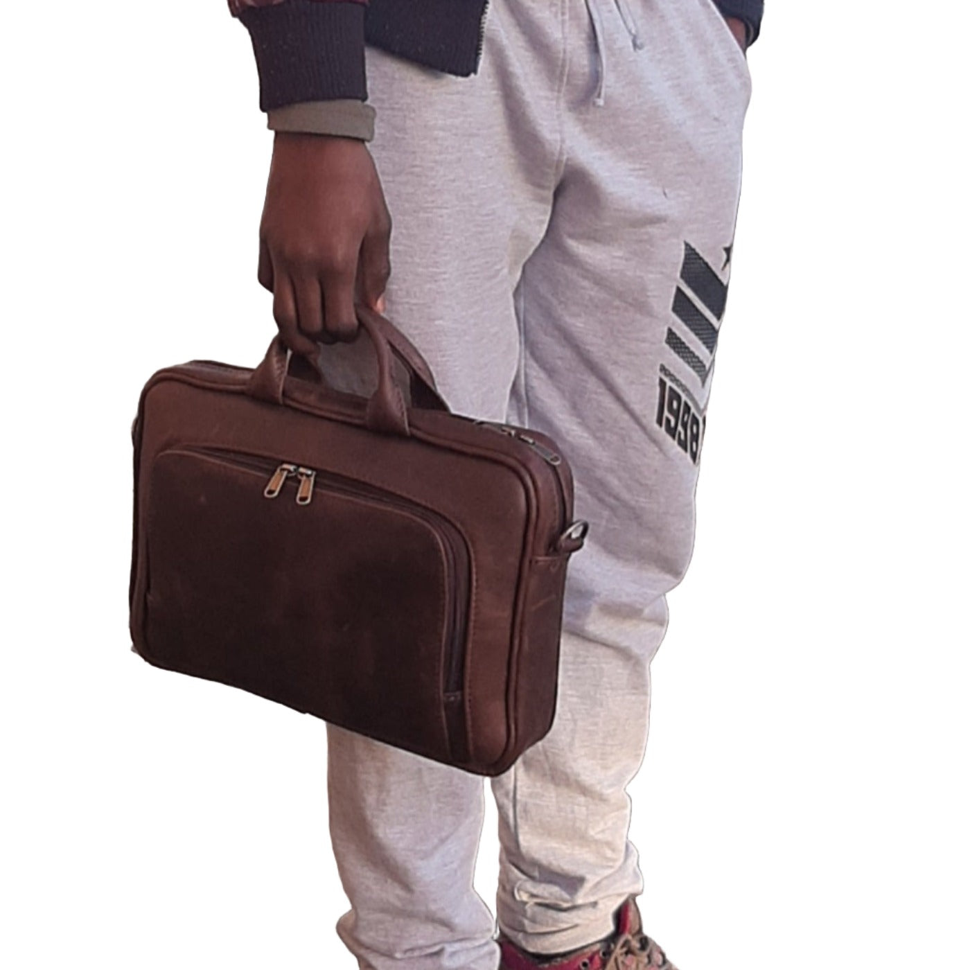 A boy carrying a genuine leather A4 laptop bags 12 inche  - Diesel Pitstop Rust  outside Cape Masai Leather shop