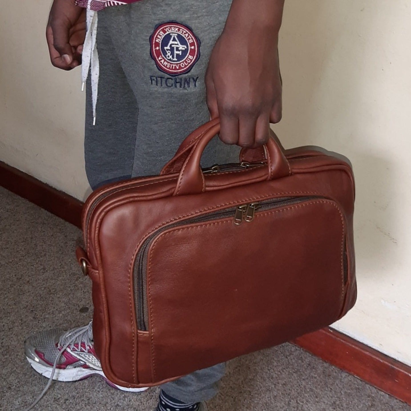 A man carrying beautiful  A4 laptop bags 12 inche inside Cape Masai Leather  office