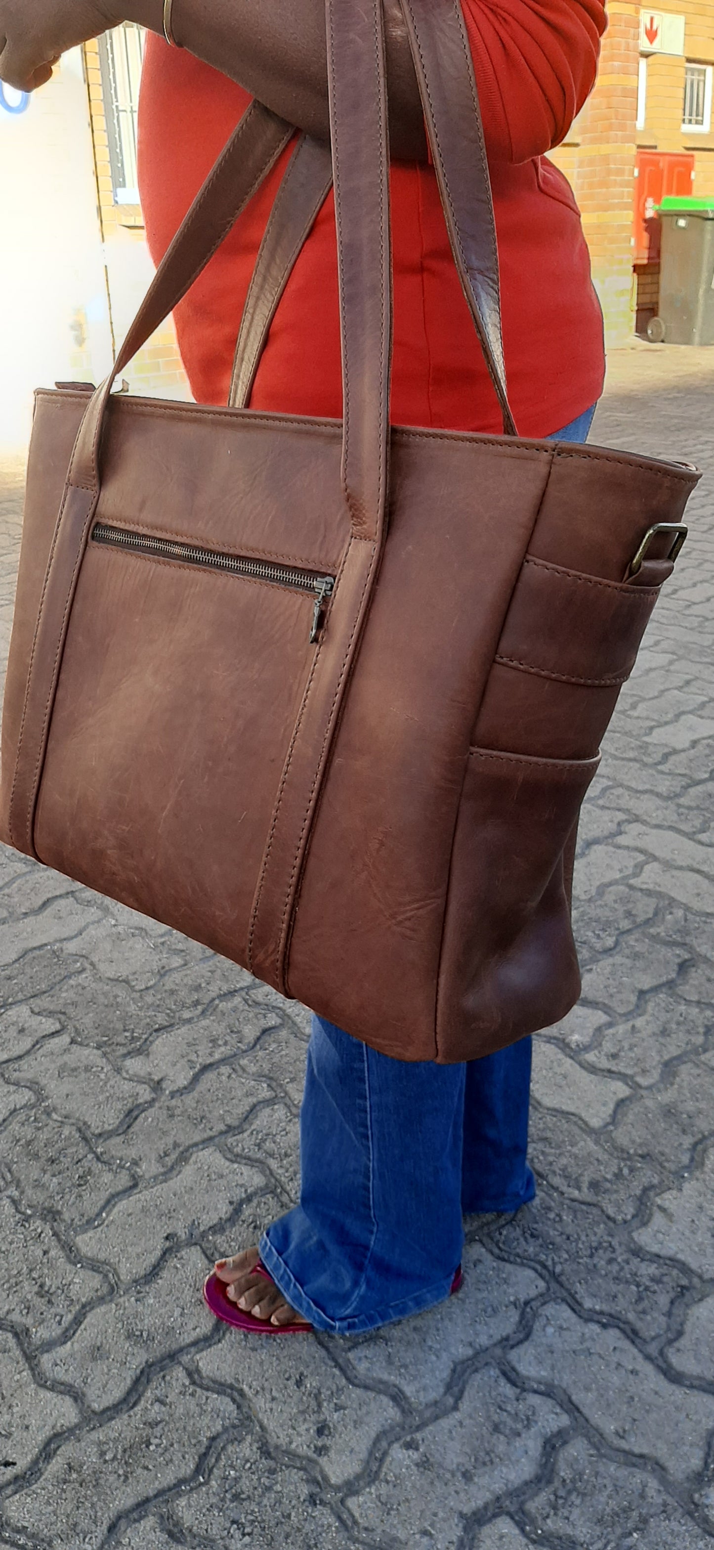 A lady carrying a beautiful big geniune leather Lady's laptop bag at Cape Masai leather in Viking Business Place.