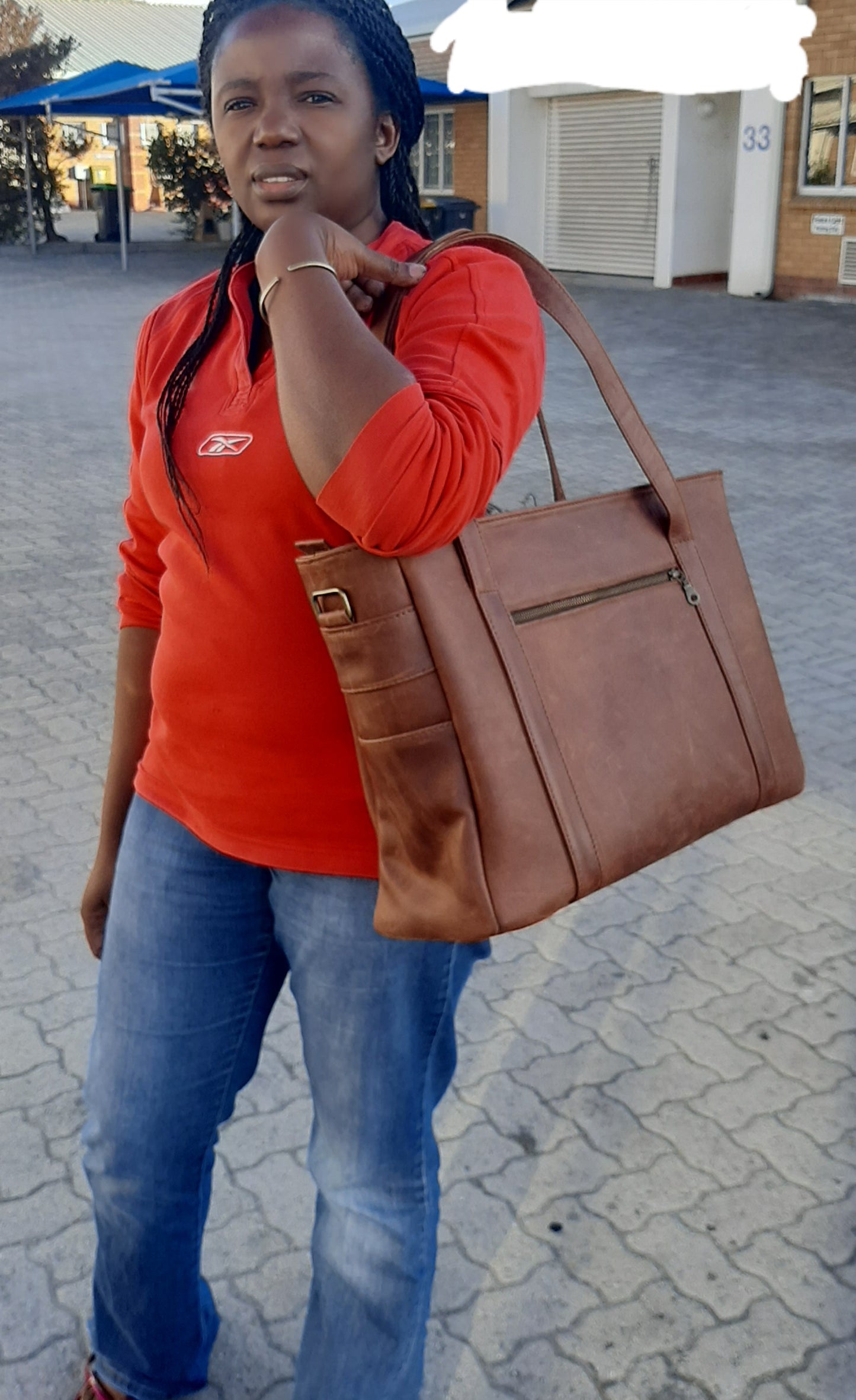 A lady carrying a beautiful big geniune leather Lady's laptop bag at Cape Masai leather in Viking Business Place.