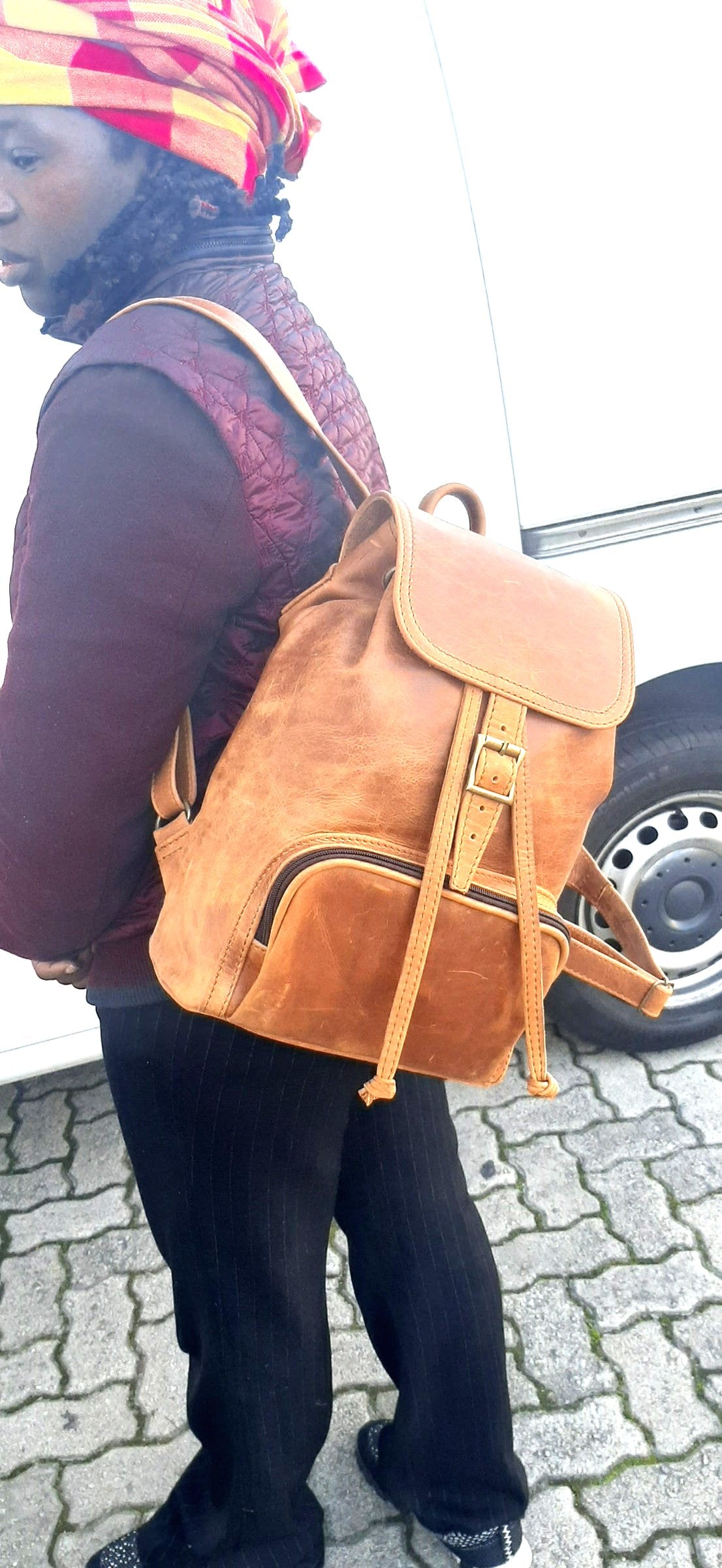 A lady carrying a beautiful genuine leather backpack with flap from Cape Masai Leather