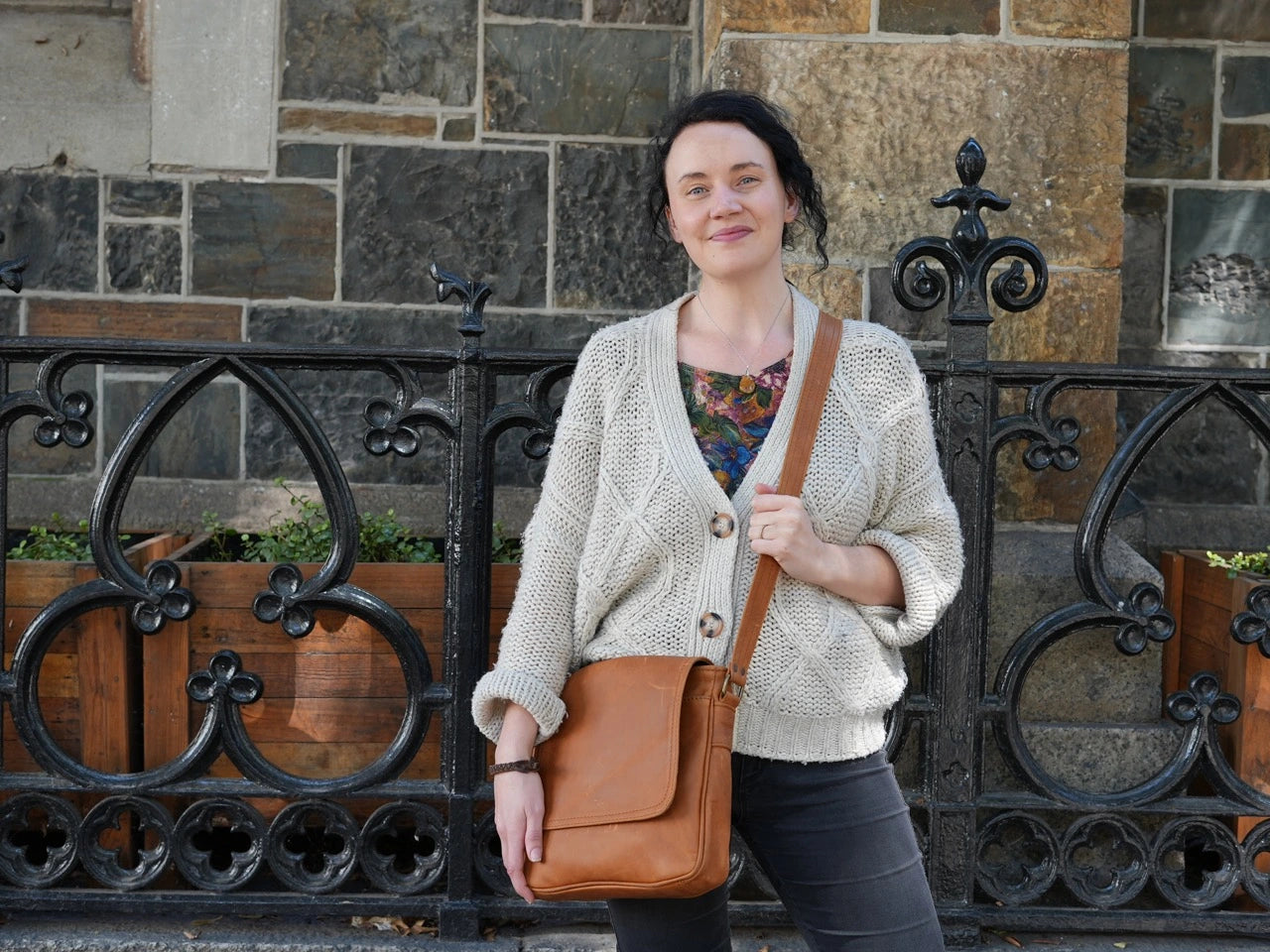 A beautiful lady carrying a beautiful crossbody Sheryl leather bags from Cape Masai leather at Green market Square in Cape Town
