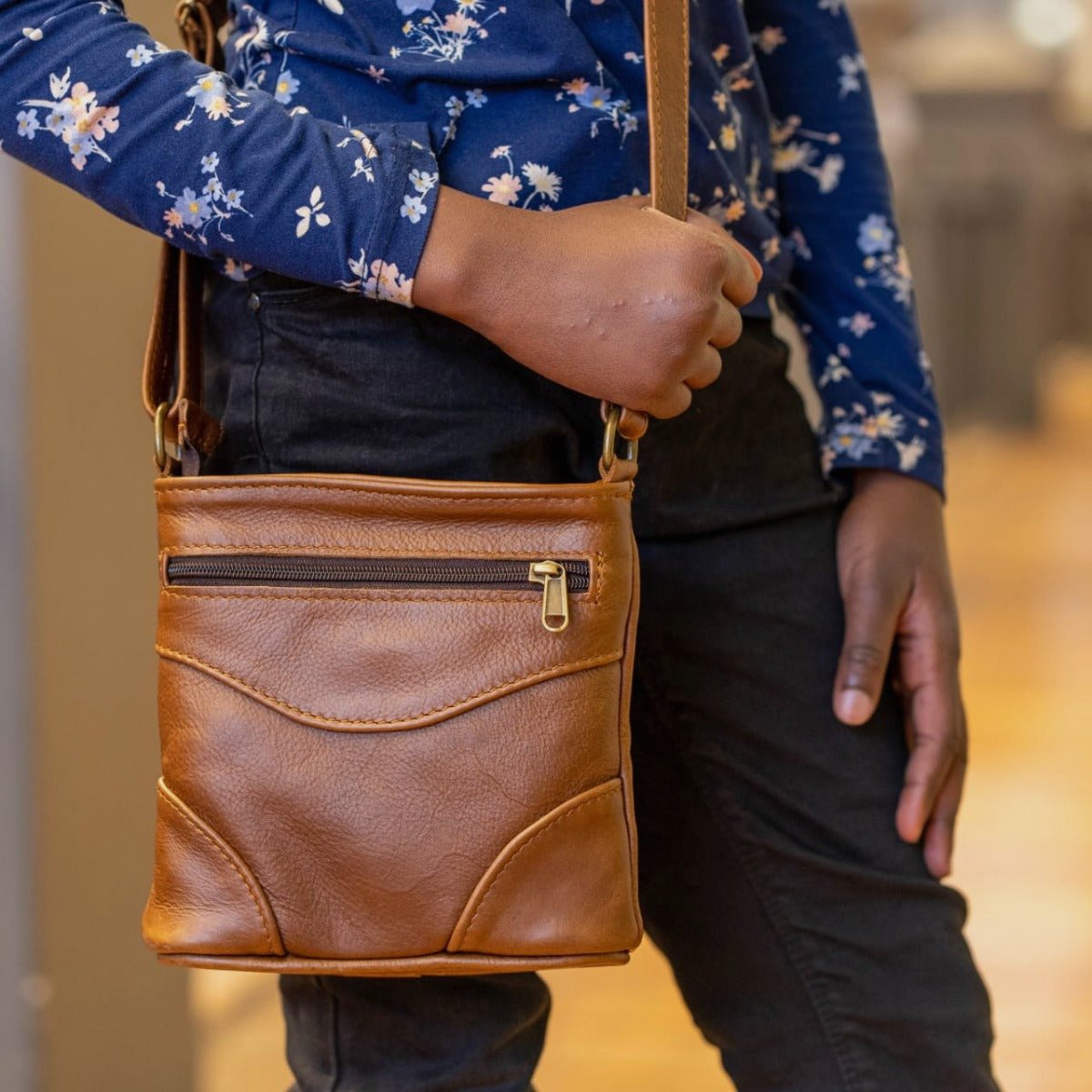 A girl carring sling bag short Pecan tan