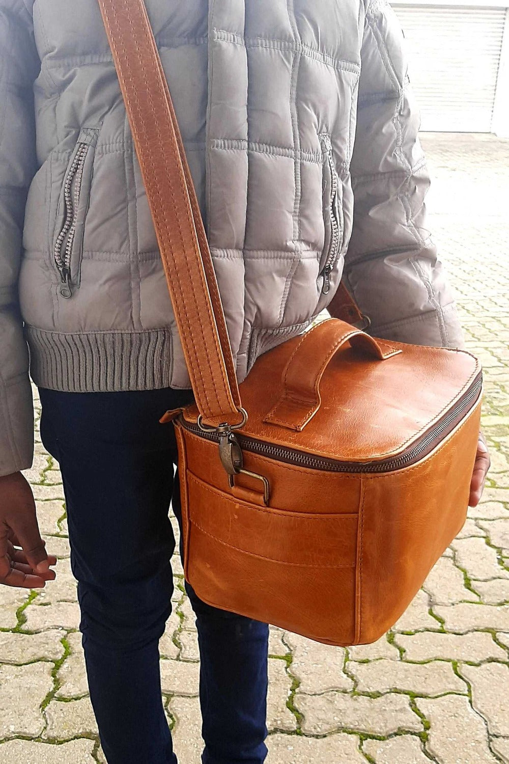 A little girl carrying Vanity bag small with shoulder strap