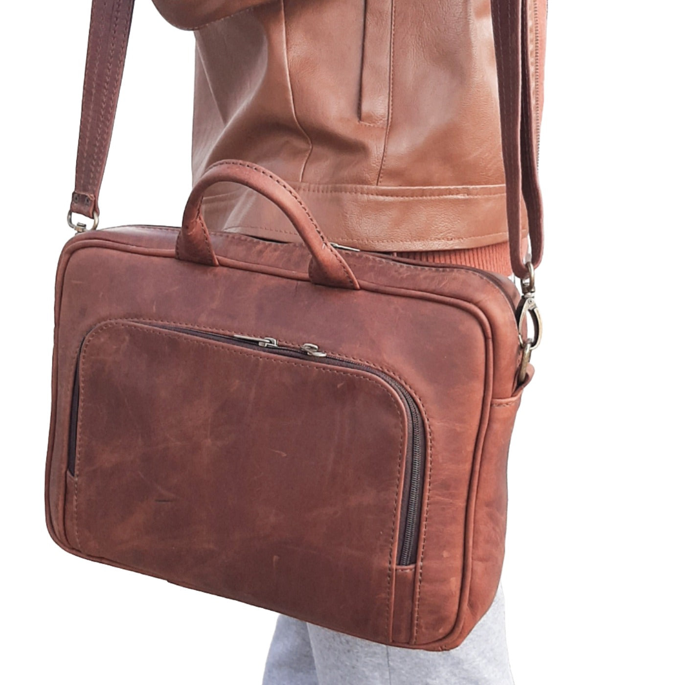 A young man carrying iconic 14 inches laptop briefcase in Diesel Pitstop ciger from Cape Masai Leather