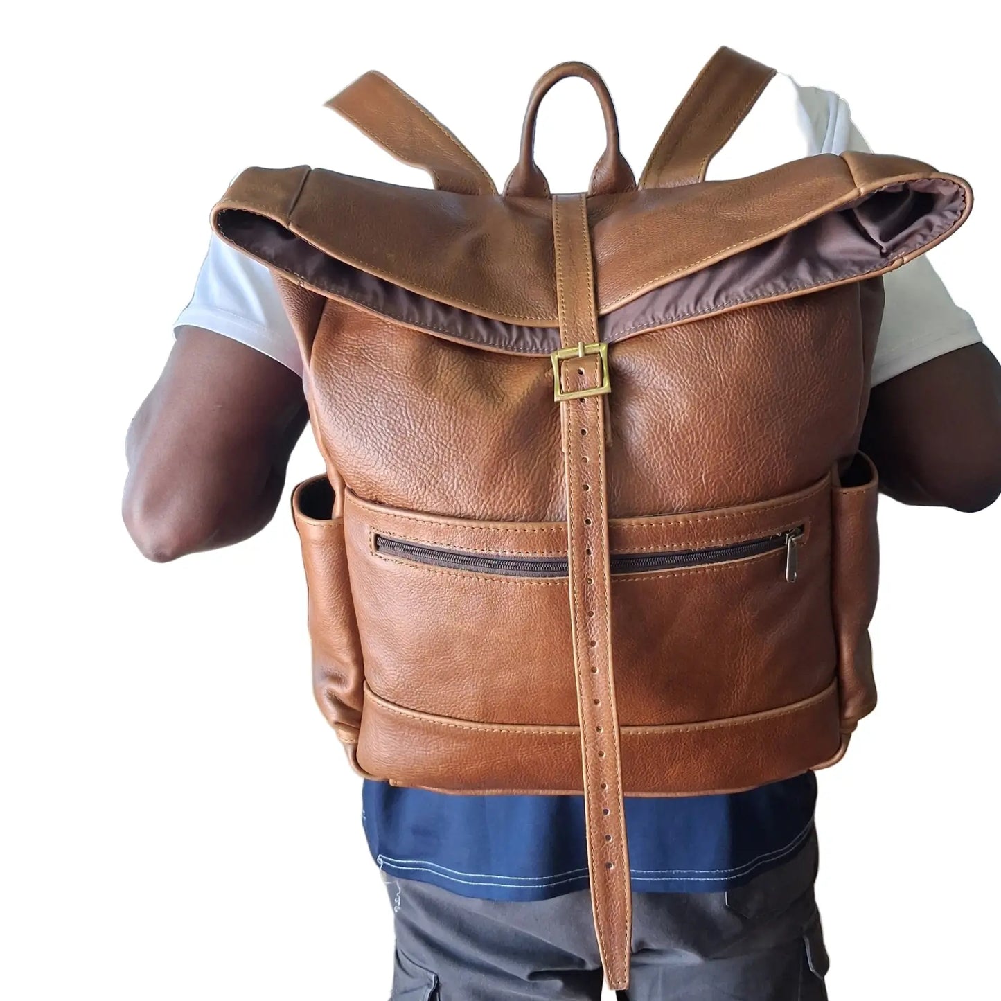 A man carrying Barutile Leather Backpacks pecan tan colour on the back