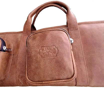 a front pocket of Cape Masai Leather rifle bag / guitar case in bitter brown on a white background with Cape Masai Logo.