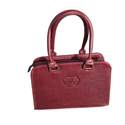Cape designer bag small in pitstop cigar handbag with double top handles and a shoulder strap, 
The bag has an embossed logo patch on the front.