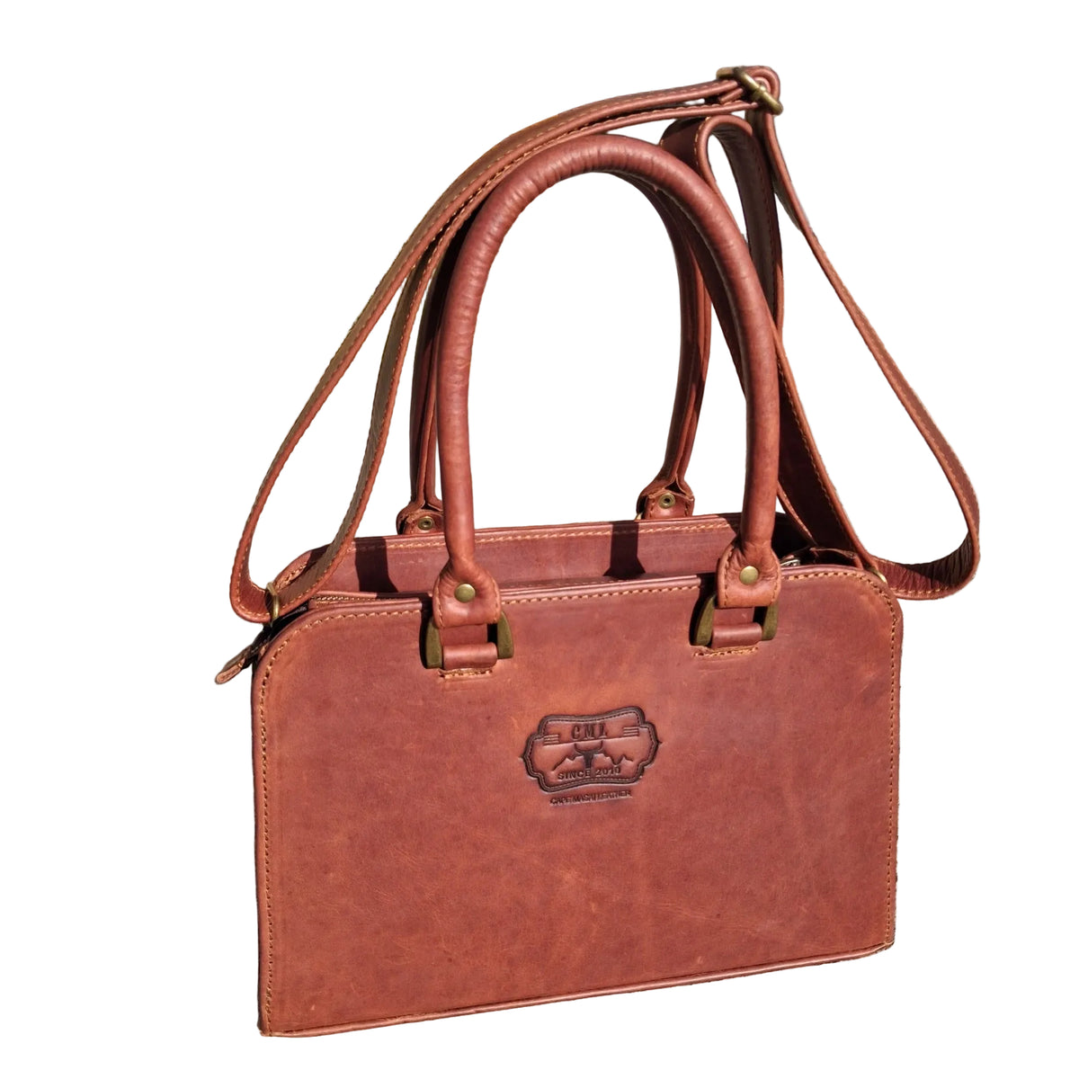 Cape designer bag small in pitstop cigar handbag with double top handles and a shoulder strap, 
The bag has an embossed logo patch on the front.
