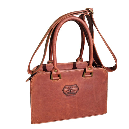 Cape designer bag small in pitstop cigar handbag with double top handles and a shoulder strap, 
The bag has an embossed logo patch on the front.