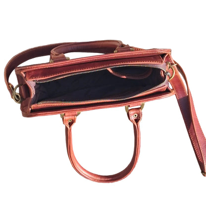 Cape designer bag small in pitstop cigar handbag with double top handles and a shoulder strap, with zip opened
