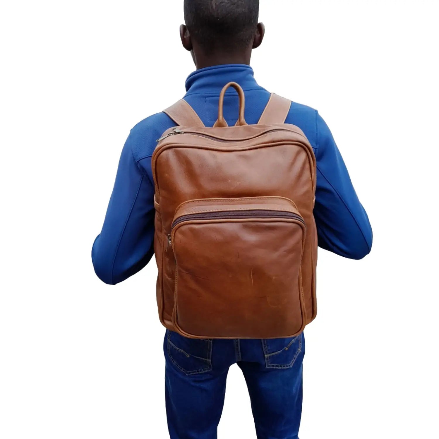 A boy carrying Everyday Leather Backpacks XL in pecan tan colour from Cape Masai Leather