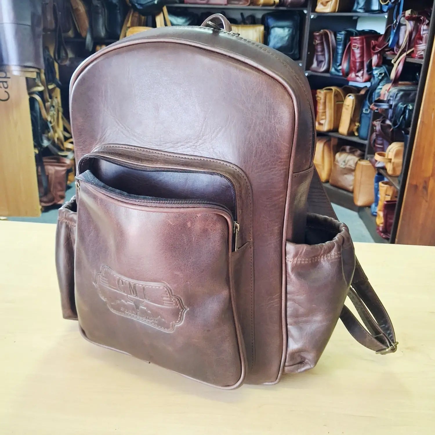 Ilone Laptop backpacks 15 inches pitstop rust with side pockets on the shop counter top.