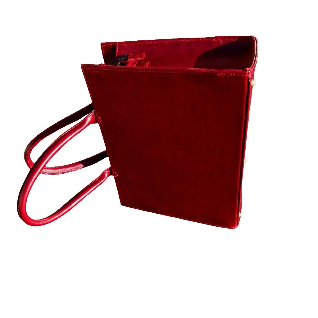 Kirstein 14" Laptop bag in cherry red colour with a gold zipper on a white background