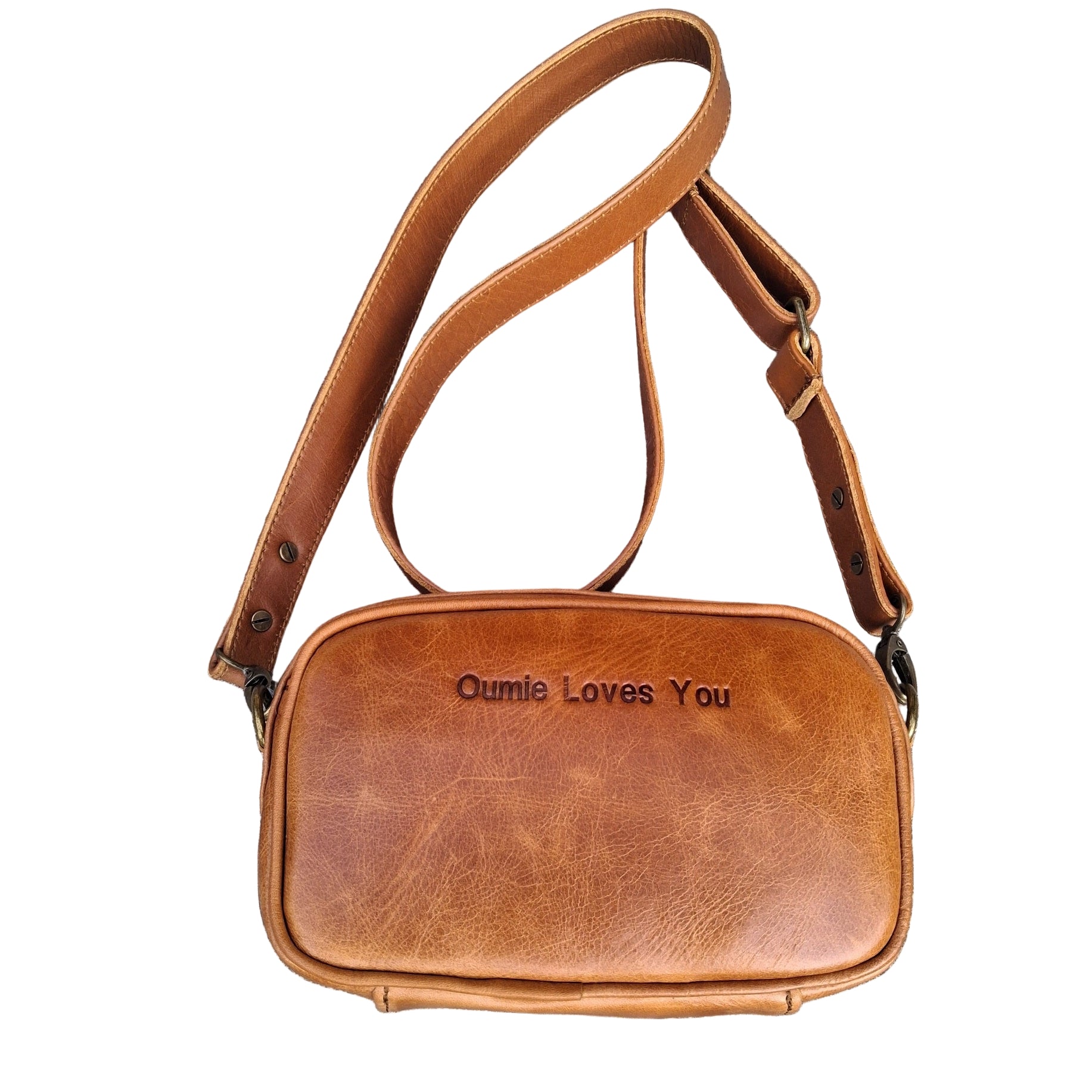 Lady X Leather Sling light Brown tan colourleather bag with 'Dadie Loves You' text on a textured surface