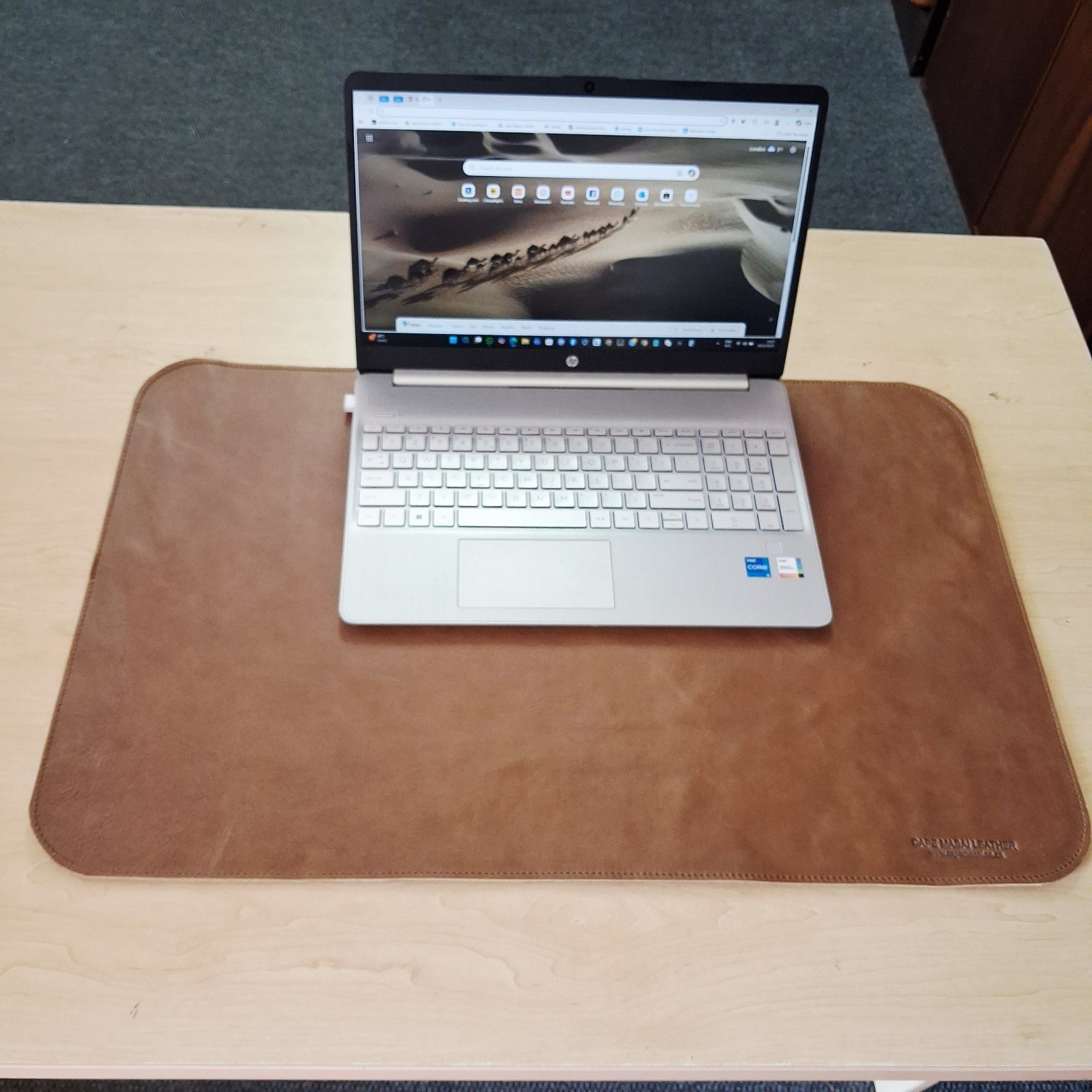 A Laptop on the Laptop Leather Mat in pecan tan