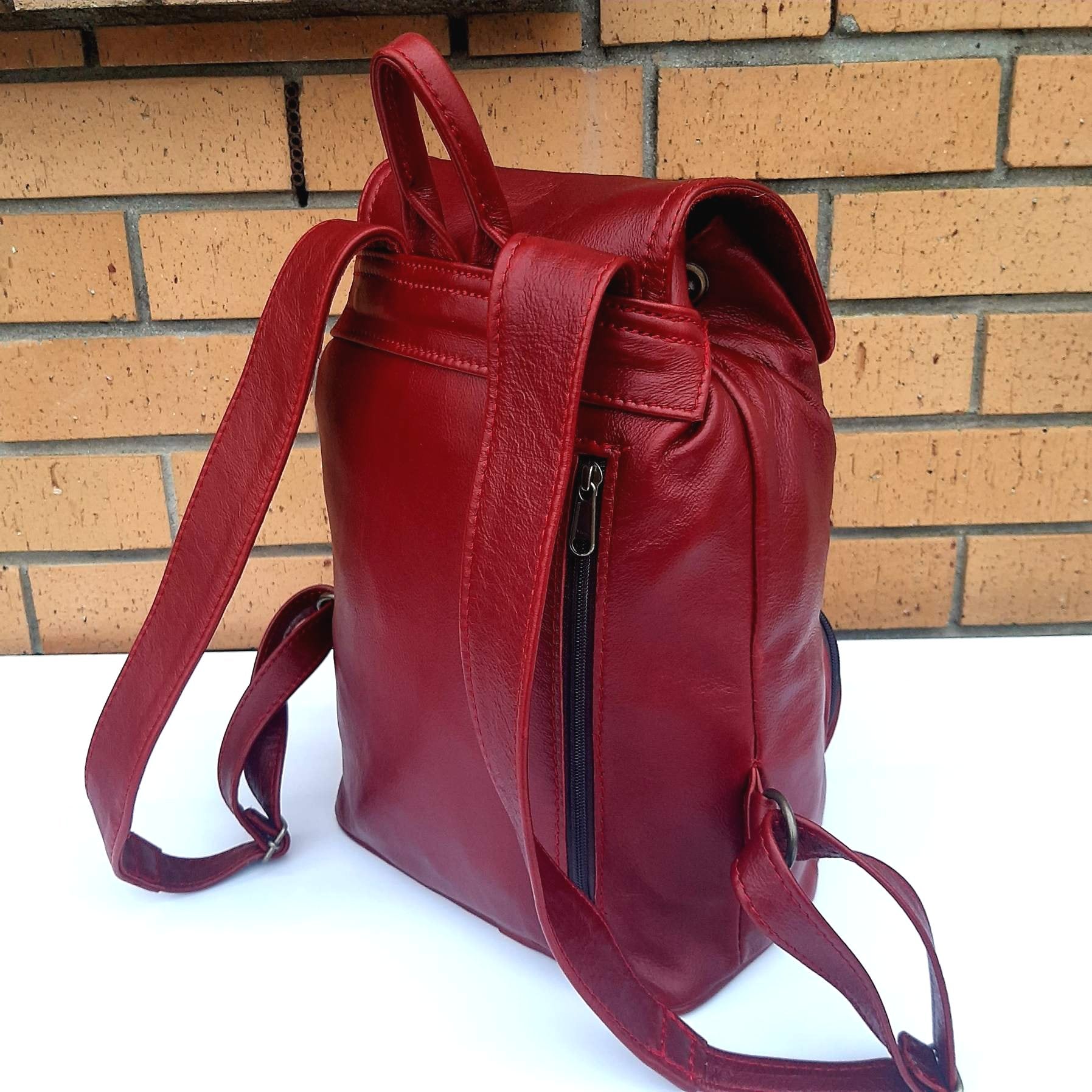 leather backpacks flap backside  in cherry red  colour made by Cape Masai Leather