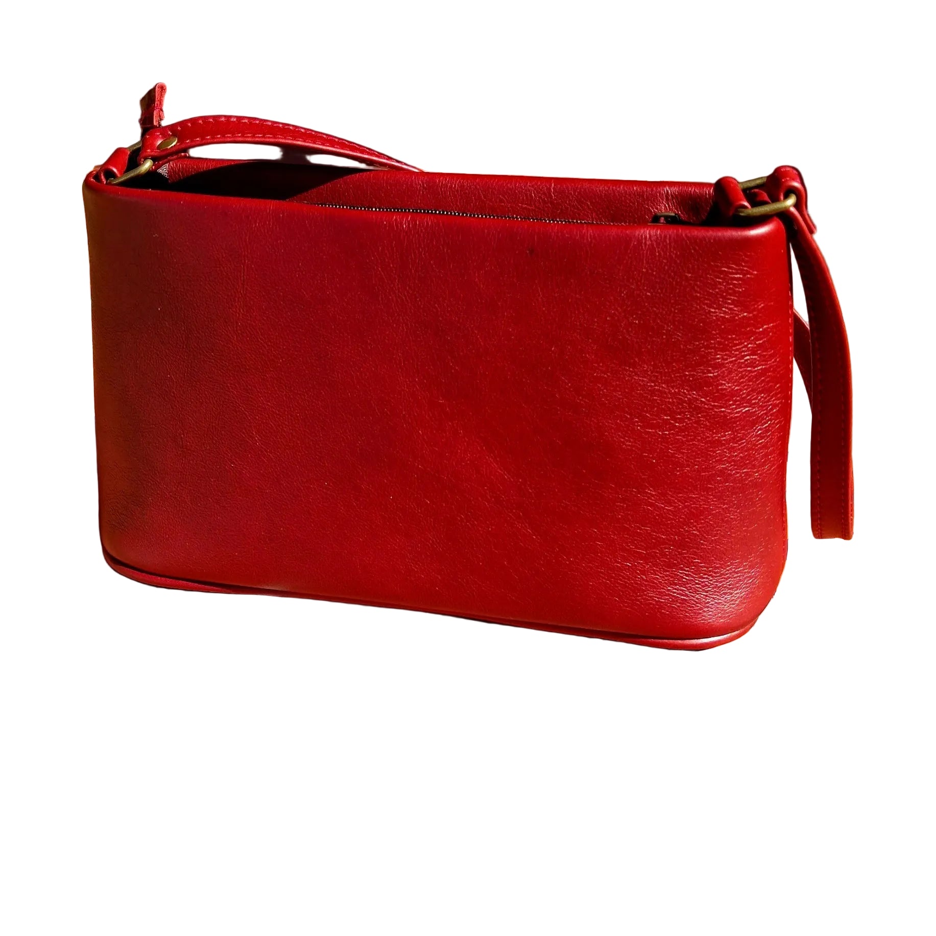 A cherry red Lucy Women's Genuine Leather Mini Shoulder with a top zipper and a single strap, resting on terracotta tiled outdoor steps.