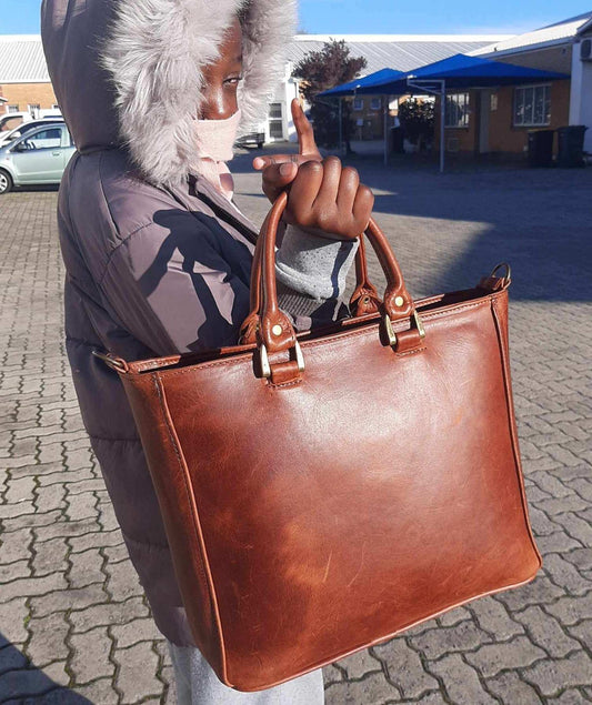 A girl carrying MDL ladies Laptop bags Small in pitstop cigar.