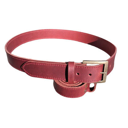 Dark red leather belt on a white surface with a blurred background