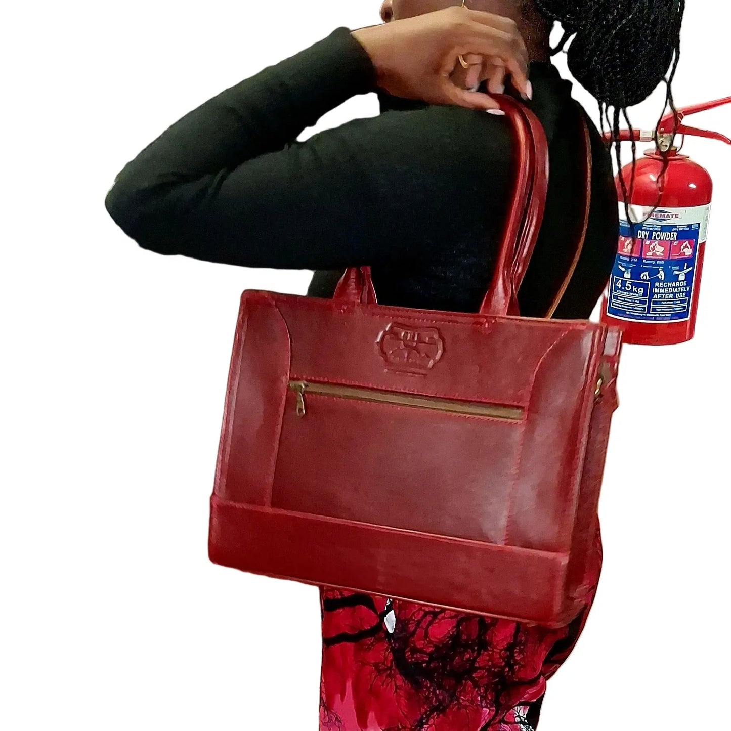 Woman holding Kirstein 14 inches laptop bag in cherry red colour from Cape Masai Leather. 