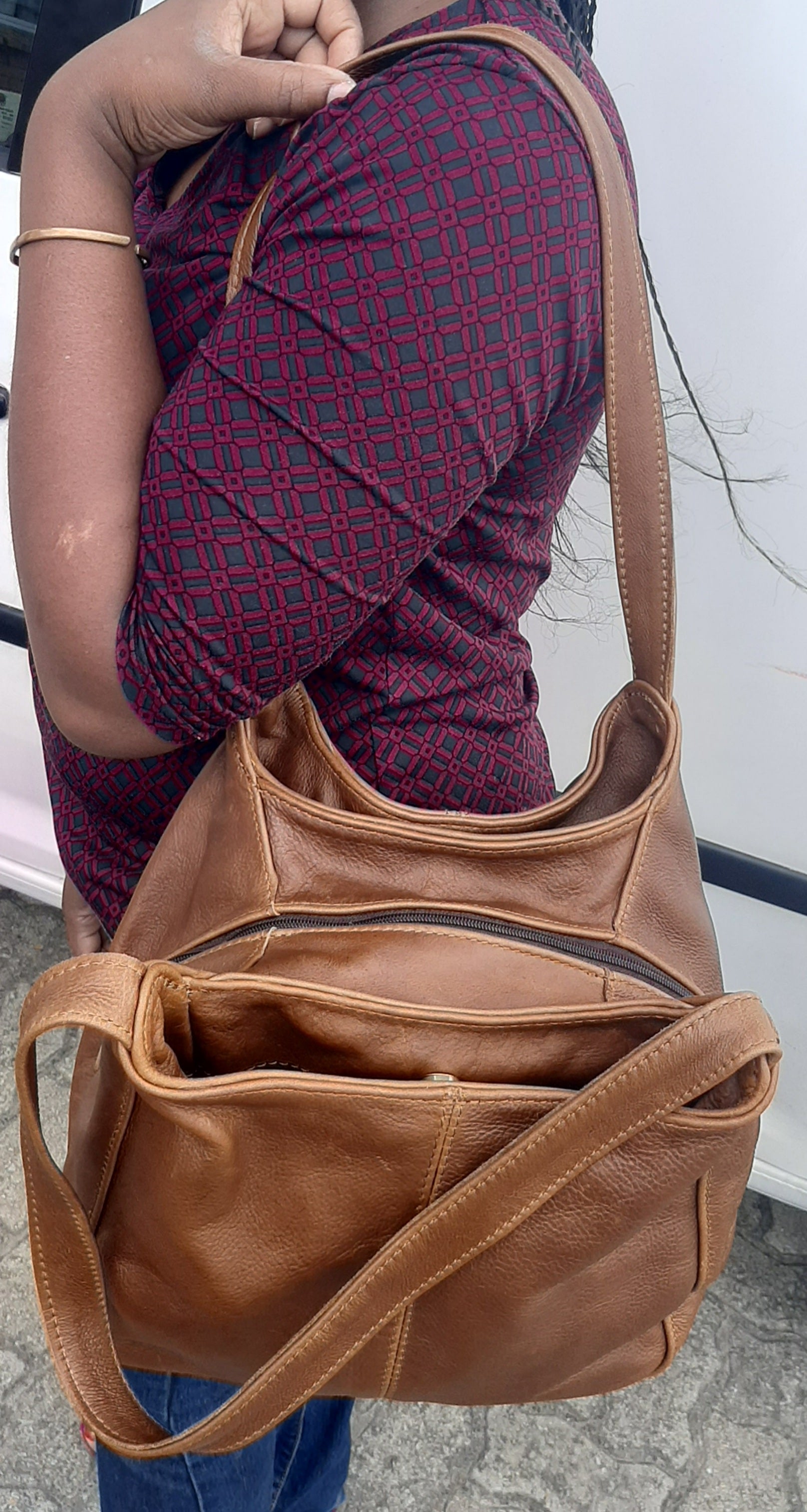 A lady carrying beautiful brown tan corra leather bag from Cape Masai Leather .