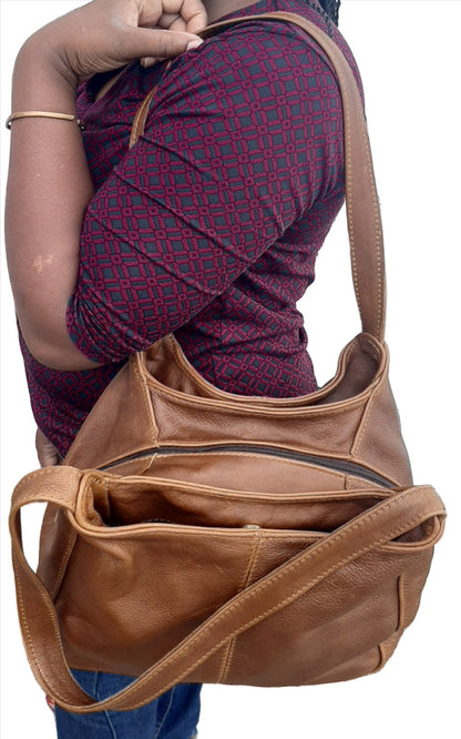 A lady carrying beautiful brown tan corra leather bag from Cape Masai Leather .