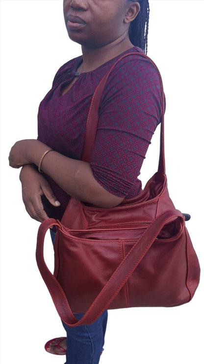 A lady carrying beautiful cherry red/dark red corra leather bag from Cape Masai Leather .