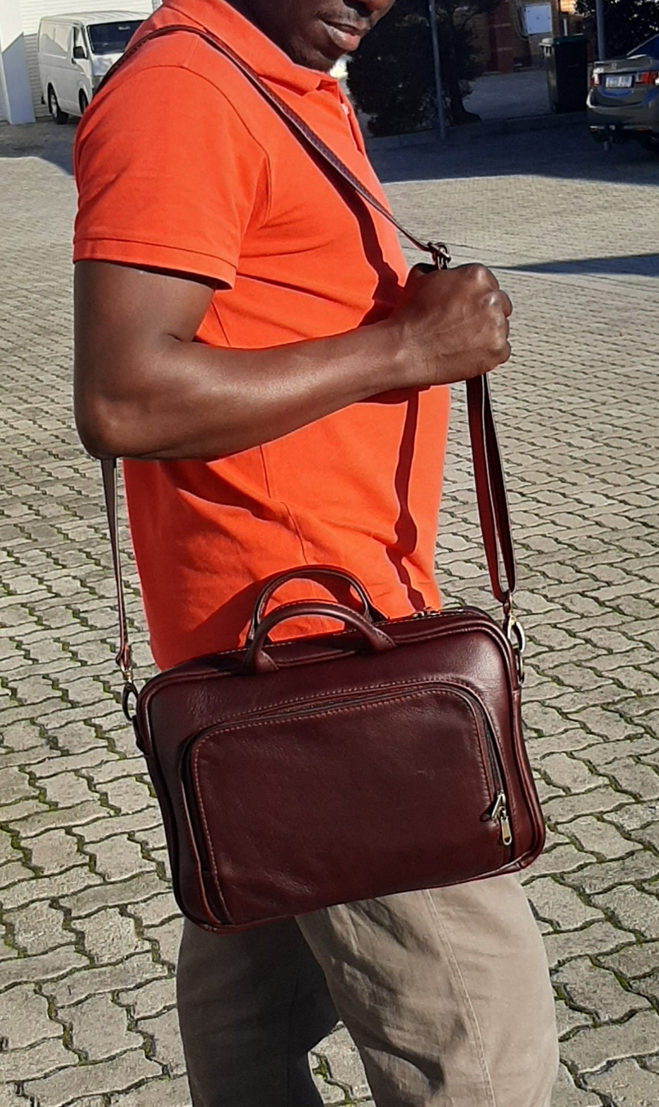 A man carrying beautiful genuine leather A4 laptop bags 12 inche outside Cape Masai Leather shop