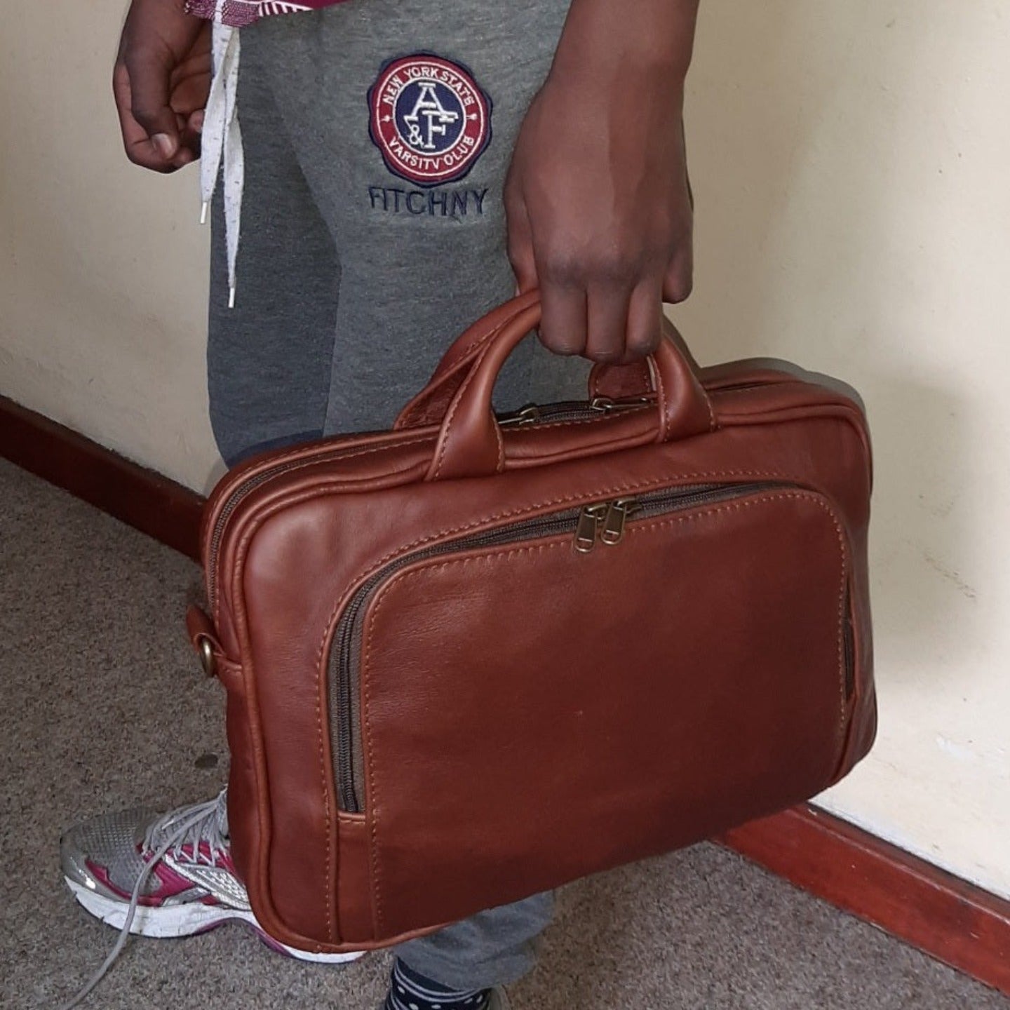 A man carrying beautiful  A4 laptop bags 12 inche inside Cape Masai Leather  office 