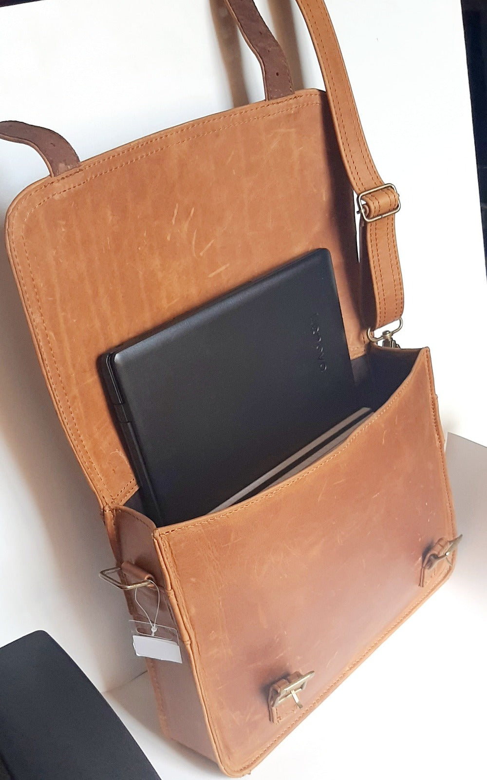 A beautiful genuine leather hand made Carryn 13-14" laptop bag with a Lenovo laptop and A4 books