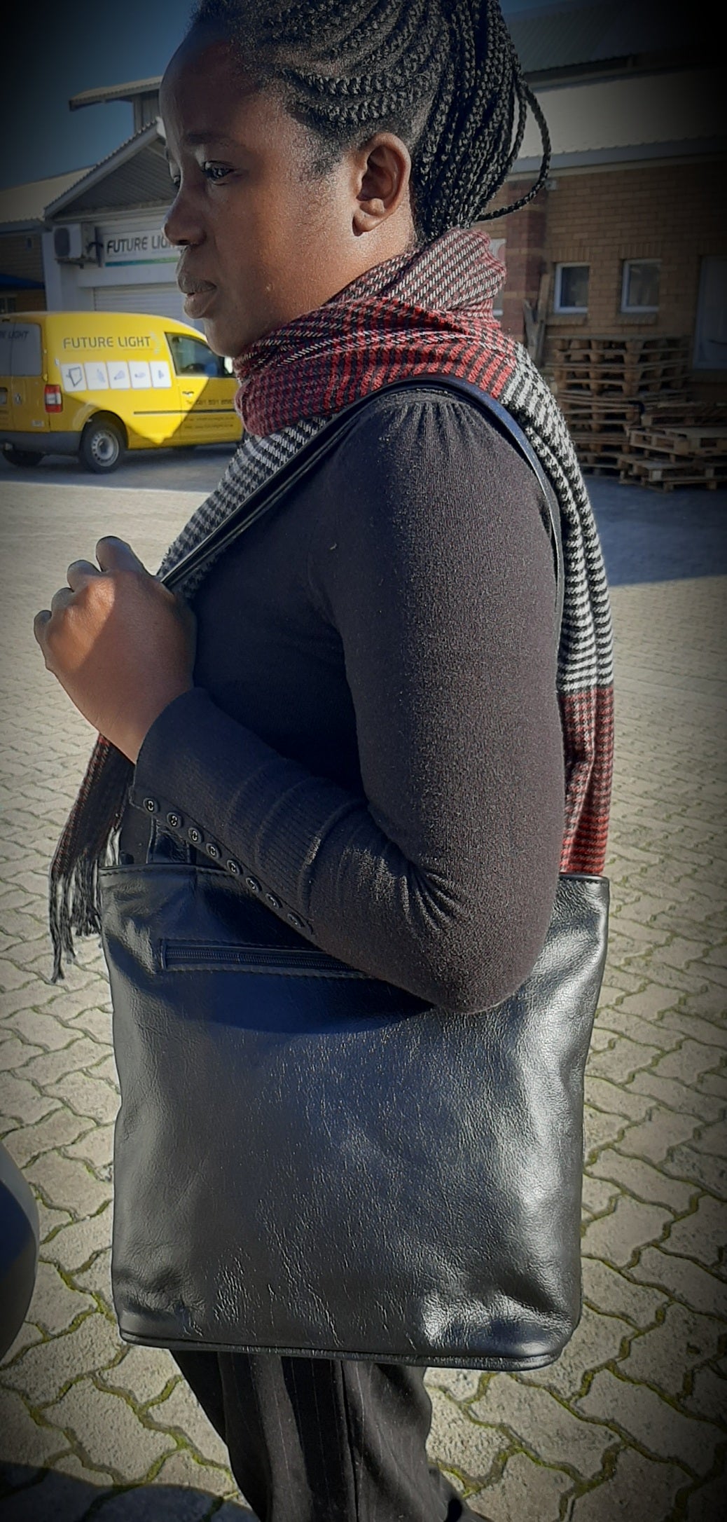 A lady carrying beautiful black Cm small leather bags from Cape Masai Leather