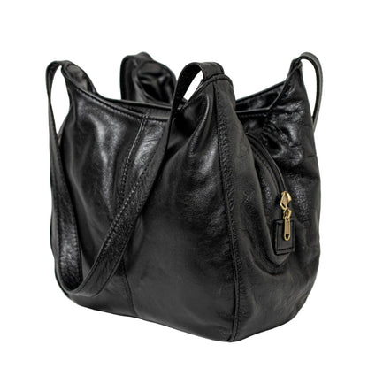 A smiling lady carrying beautiful black corra leather bag from Cape Masai Leather.