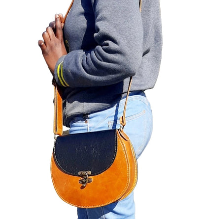 A beatiful  lady carrying a beautiful Crossbody "D Bag big leather bags / Mini Sandle bags" at Cape Masai leather in Cape Town  